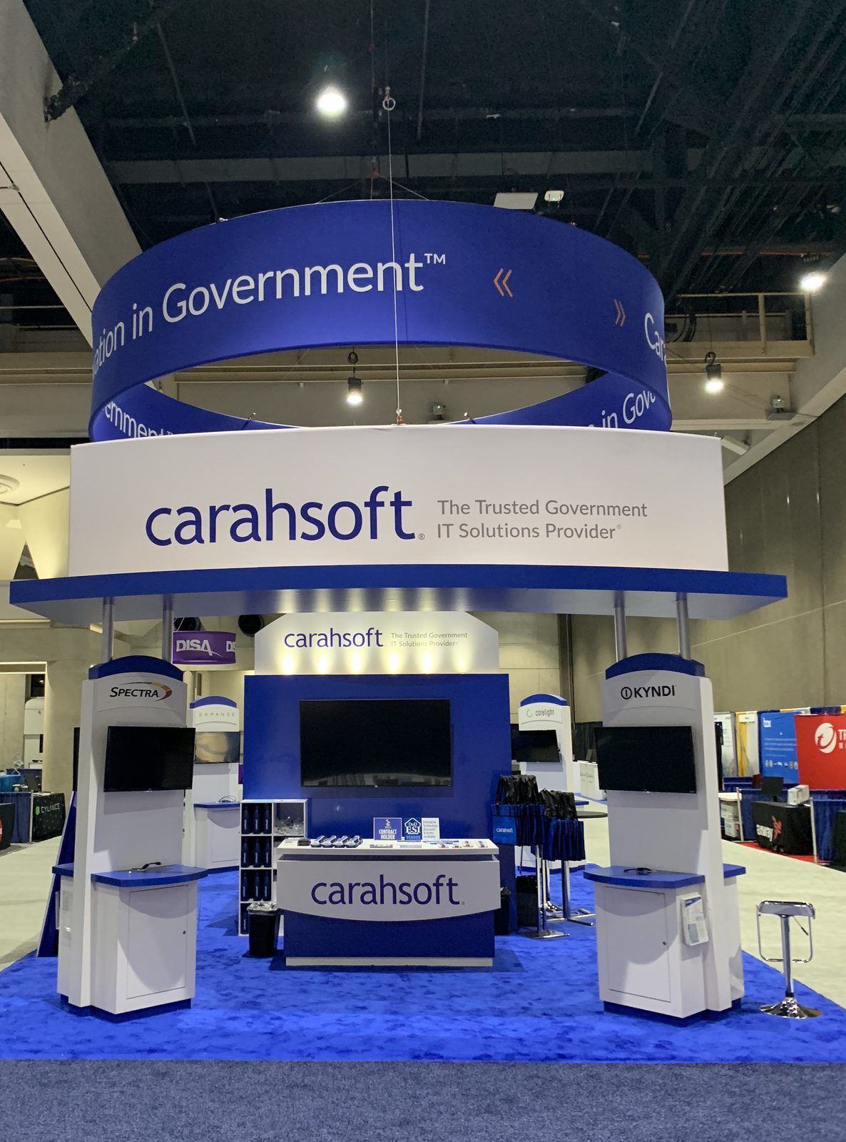 Two story exhibit with overhead ring signage, built by DSM Exhibits