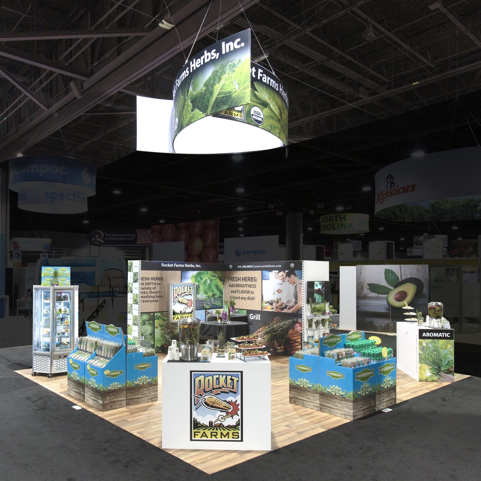 Exhibit with hanging drum sign and product displays, built by DSM Exhibits